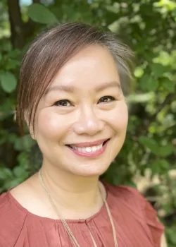 Carolyn Thao Phan, LMSW therapist at Bright Spot Counseling in Farmington Hills, MI, smiling outdoors