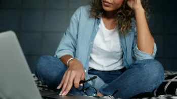 Woman researching therapists on a laptop, representing the process of finding an in-network therapist