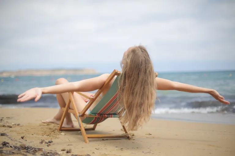 Woman relaxing on a beach chair at the beach beach