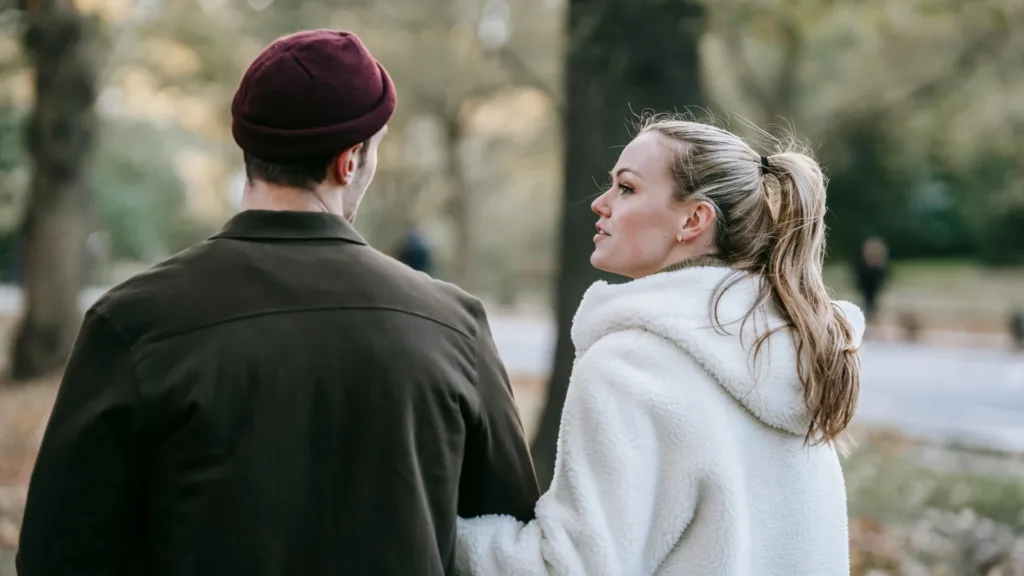 Couple walking and talking in a park, engaged in a meaningful conversation