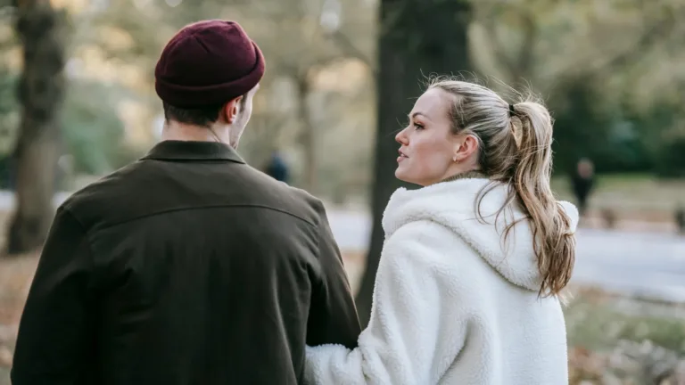 Couple walking and talking in a park, engaged in a meaningful conversation