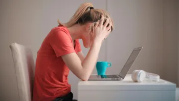 Woman On Computer Looking For Help With Anxiety