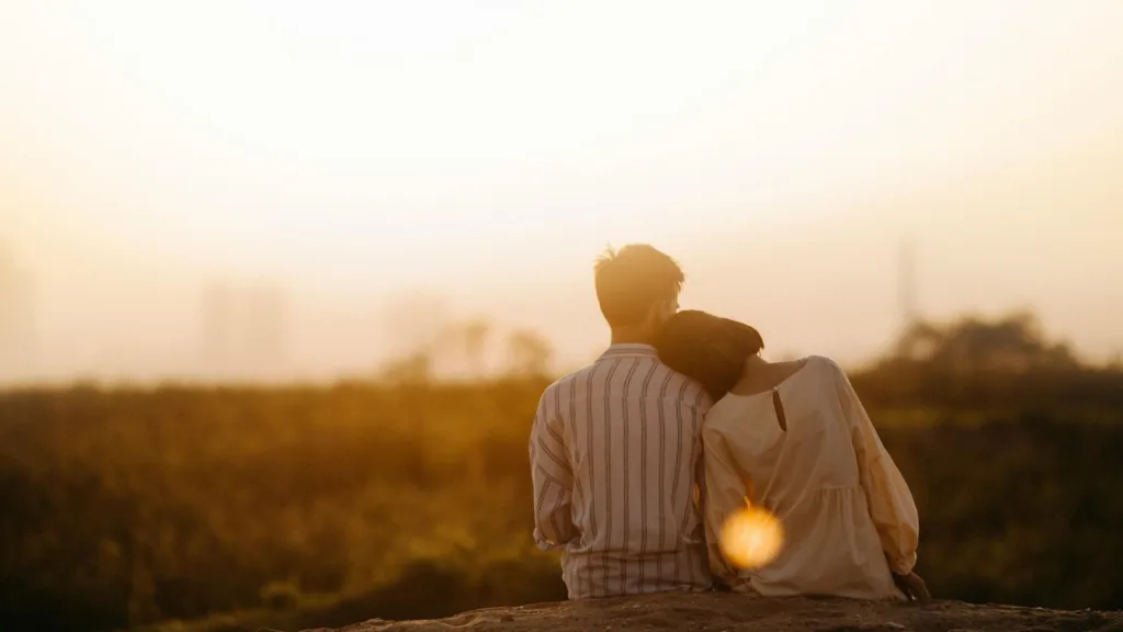Couple sitting together at sunset, symbolizing emotional connection during Couples Retreats at Bright Spot Counseling