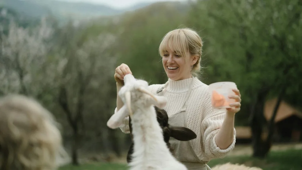 Woman engaging in goat-assisted DBT therapy outdoors at Bright Spot Therapy in Michigan