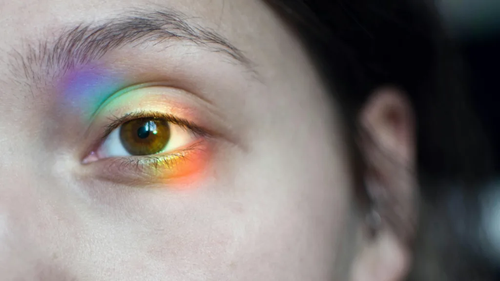 Close-up of an eye illuminated with a rainbow reflection, symbolizing emotional insight and trauma processing in EMDR therapy
