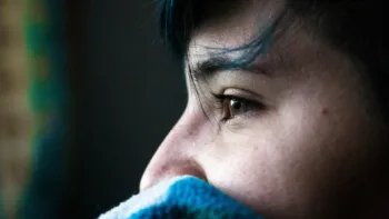 Close-up of a person looking out a window, symbolizing emotional healing through half-day EMDR therapy in Farmington Hills, MI