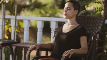 Woman practicing mindful breathing during somatic therapy session in Farmington Hills Michigan