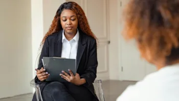 Therapist reviewing notes with a client during a counseling session
