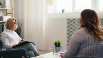 Therapist and client in warm conversation during online therapy MI session, exploring what emotions are showing up