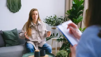 Therapist listening to a young woman during a counseling session, discussing control and emotional regulation