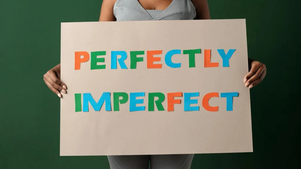 Woman Holding Perfectly Imperfect Sign
